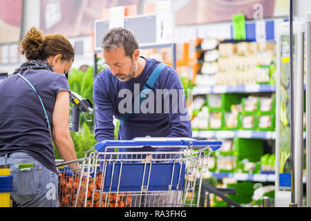 Daily real couple buy food and beverages at the big store market after work - together forever in relationship during normal lifestyle - family coucep Stock Photo