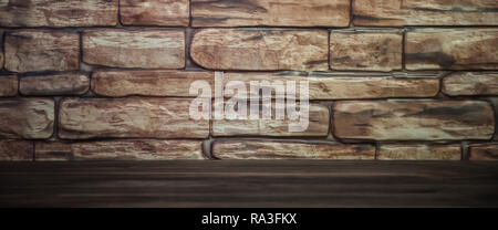 Background of a brick wall with a wooden table lit by light. Stock Photo