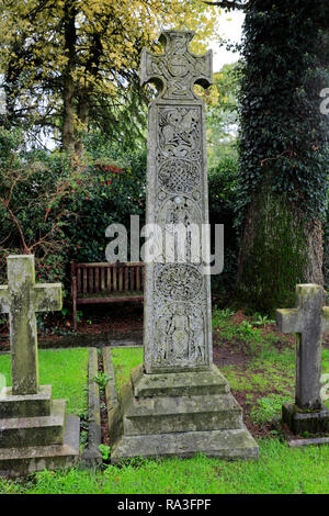 The Ruskin Cross marks John Ruskin's grave, St Andrews Church, Coniston town, Cumbria, Lake District National Park, England, UK Stock Photo