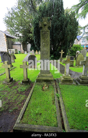 The Ruskin Cross marks John Ruskin's grave, St Andrews Church, Coniston town, Cumbria, Lake District National Park, England, UK Stock Photo