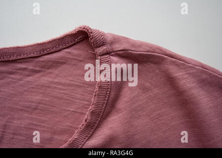 Pink cotton t-shirt detail isolated on white background close up Stock Photo