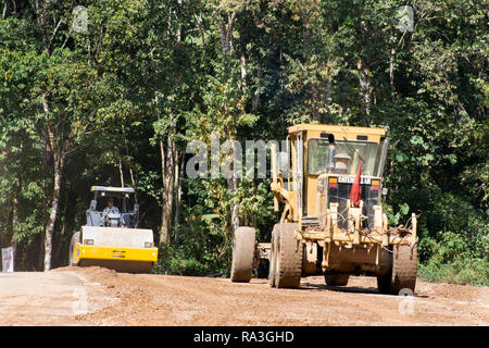 Asian thai workers use heavy machinery motor grade and vibratory roller working made and build road at Doi Tung mountain on February 22,2018 in Chiang Stock Photo