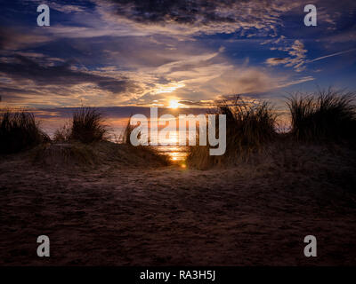 Sunset beyond sand dunes on West Wittering beach near Chichester, West Sussex. Stock Photo