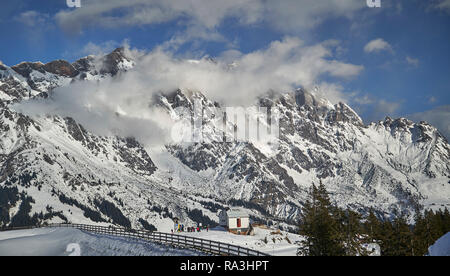 Hochkönig mountains in winter, partially hidden in clouds Stock Photo