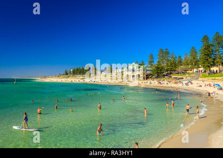 Cottesloe, Western Australia - Jan 2, 2018: white sand, calm turquoise waters for snorkeling at Cottesloe, Perth's most famous beach, Indian Ocean. Cottesloe Surf Lifesaving Club on background Stock Photo