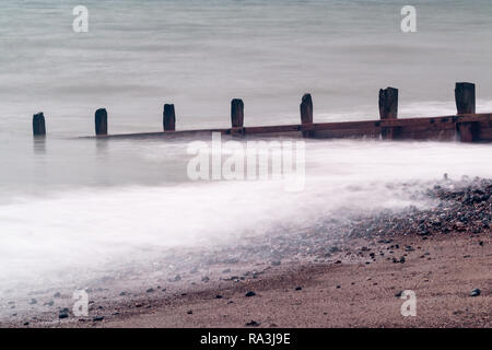 Worthing beach captured using a slow shutter speed so that the sea looks smooth. Stock Photo