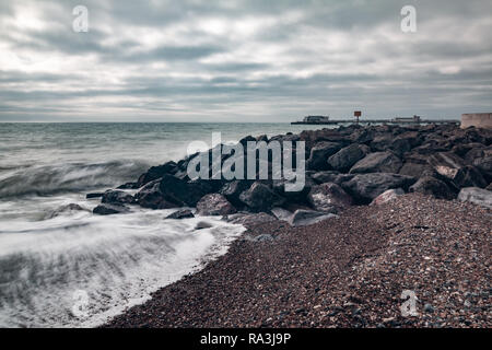 Worthing beach captured using a slow shutter speed so that the sea looks smooth. Stock Photo