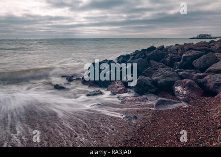 Worthing beach captured using a slow shutter speed so that the sea looks smooth. Stock Photo