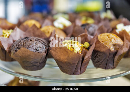 a variety of little muffins on glass plate closeup Stock Photo
