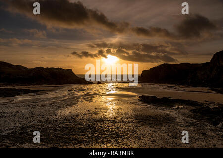 Sunset over the sea at Porth Dafarch, Anglesey, North Wales Stock Photo