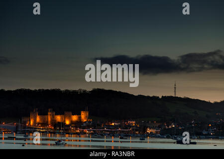 Conway castle at dusk on the North Wales coast Stock Photo