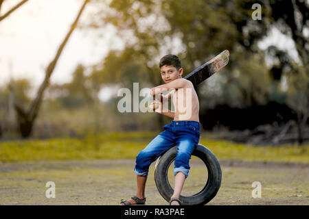 Rural Indian Child Playing Cricket Stock Photo