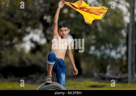 Rural indian child playing at ground Stock Photo