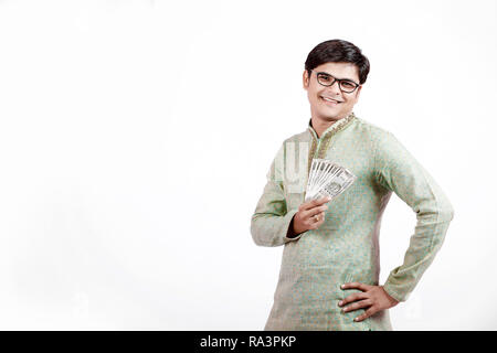Indian man holding Indian currency note in hand Stock Photo