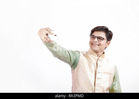 young Indian man taking selfie with mobile Stock Photo