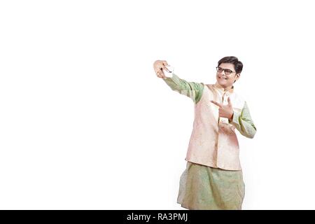young Indian man taking selfie with mobile Stock Photo