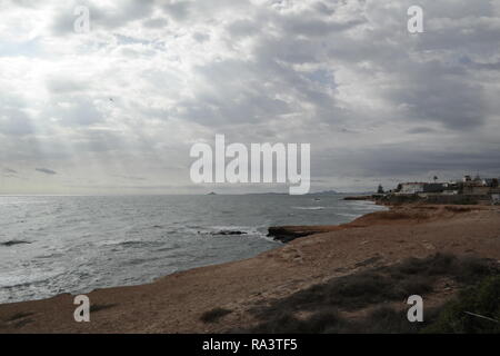 Sunbeams over the sea  with a moody afternoon sky Stock Photo