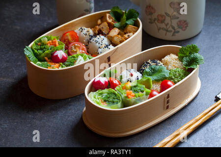 Colorful vegan bento lunch box with green vegetables and tofu Stock Photo