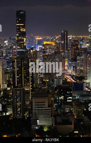 Night view of Bangkok skyline and illuminated high-rise buildings along ...