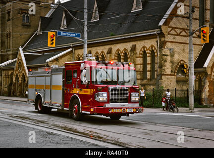 Fire truck racing along street, responding to emergency, Toronto, Ontario, Canada Stock Photo
