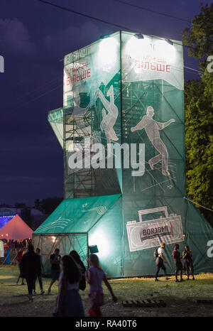 KIEV, UKRAINE - JULY 08, 2018: People enjoy live concert and visit night Borjomi Georgian sparkling mineral water booth at the Atlas Weekend Festival  Stock Photo