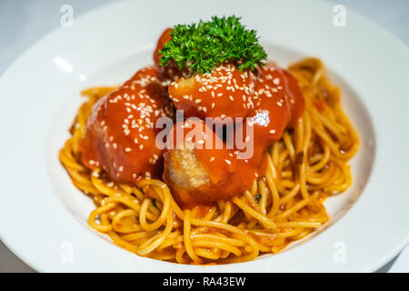 Spaghetti fried chicken cubes with tomato sauce Stock Photo