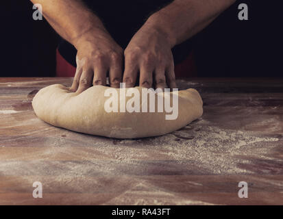 Chief baker preparing dough for bread in a bakery. Kitchen professional. Stock photo Stock Photo