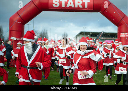 Moseley Rugby Club, Billesley Common, Birmingham, West Midlands, UK. 2nd December 2018.  Hundreds of generous-hearted Santas take part in a mass run t