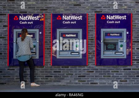 Woman at the cash dispenser of NatWest Bank, London, Great Britain Stock Photo