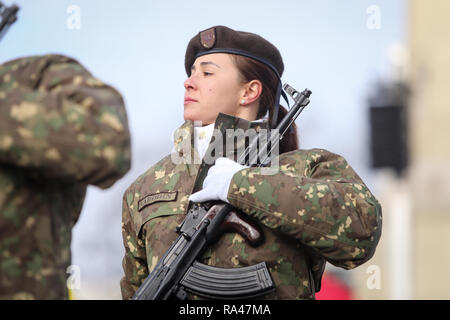 A soldier with a combat military assault rifles AK 74 stands in a field ...