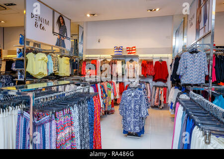 COLOMBO, SRI LANKA - SEPTEMBER 05, 2016:  Wide View of Ladies wear Clothes, Dresses, Skirts, Frocks, Trousers, Jackets, with Shelves, Racks and Hanger Stock Photo