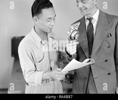 Key Nishimura with announcer Chet Huntley of CBS in a nationwide broadcast at this War Relocation Authority center for evacuees of Japanese ancestry 5/26/1942 Stock Photo