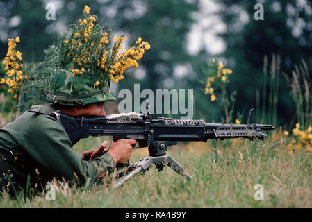 1972 or 1975 - An camouflaged infantryman armed with an M60 machine gun. Stock Photo