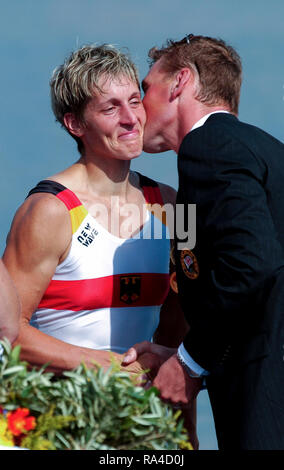 Athens, Greece, 2004 Olympic Games, Lake Schinias, [Rowing-Sun Finals day], GER W4X, Kathrin BORON, receives, a kiss from Matthew PINSENT, before he hangs her, fourth, Olympic Gold Medal, [Mandatory Credit Peter Spurrier/ Intersport Images] Stock Photo