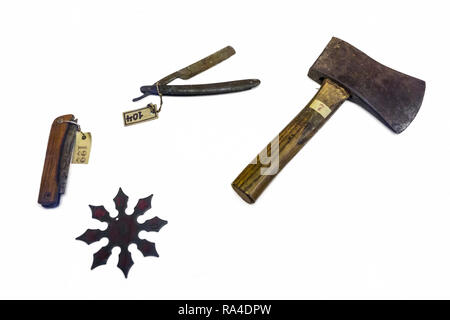 Old murder weapons against white background: pocket knife, straight razor / open razor, hand axe / hatchet and shuriken / throwing star / ninja star Stock Photo