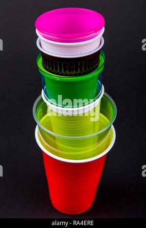 Plastic cups, many different types, shapes, colors, disposable cups, plastic waste Stock Photo