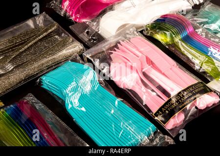 Bulk packing of plastic cutlery, disposable cutlery, knives, forks, spoons, plastic garbage, various colours, types Stock Photo