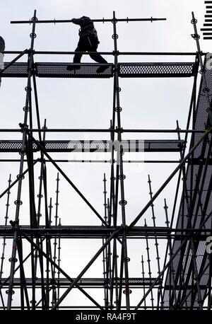 Scaffolders at work, building a large scaffolding, work at high altitude, Germany Stock Photo