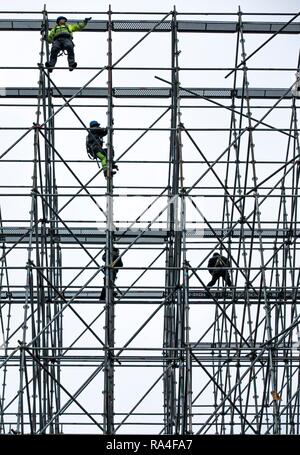 Scaffolders at work, building a large scaffolding, work at high altitude, Germany Stock Photo