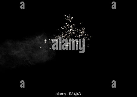 stones isolated on black background. Small granite rock stone fly isolated on black background. Stock Photo