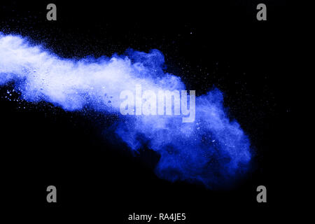 Bizarre forms of powder painted and flour combined explode in front of a black background to give off fantastic colors and forms. Stock Photo
