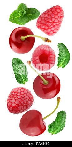 Flying cherry and raspberry fruits isolated on white background with clipping path as package design element and advertising. Full depth of field. Stock Photo
