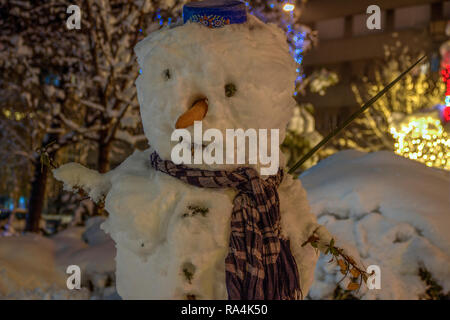 Zemun, Belgrade, Serbia - Snowman standing in a park at night Stock Photo