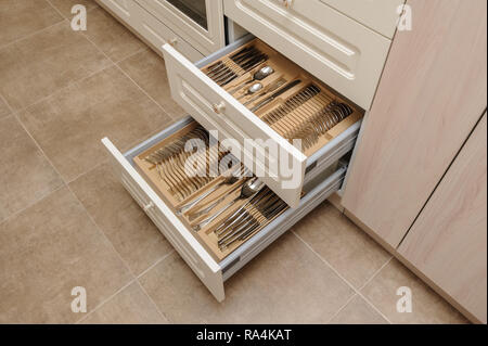 Opened kitchen drawers with silverware Stock Photo