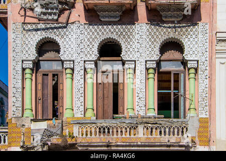 row of three ornate windows in a semi derelict house in havana Cuba caribbean Stock Photo