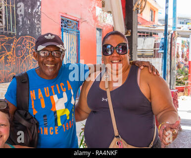 middle aged latin couple smile and embrace in a cuban street in havana cuba Stock Photo
