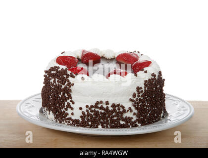 Chocolate cake frosting in vanilla cream with chocolate glaze topping surrounded by fresh cut strawberries dipped in glaze. Chocolate chip morsels pre Stock Photo