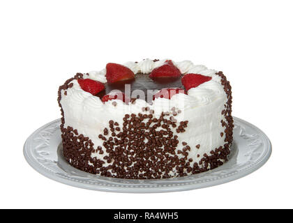 Chocolate cake frosting in vanilla cream with chocolate glaze topping surrounded by fresh cut strawberries dipped in glaze Chocolate chip morsels pres Stock Photo