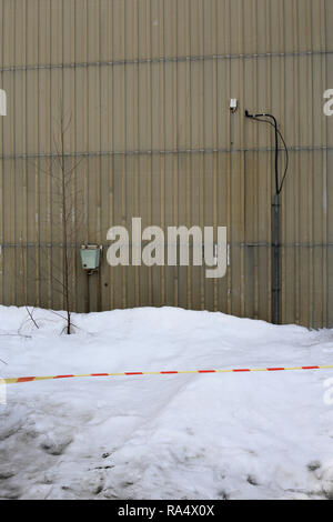 Details from an abandoned area including abandoned buildings and parking area. Photographed during a winter day with some snow. Stock Photo