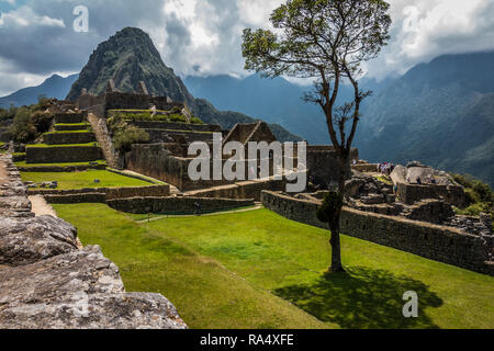 The ancient stone ruins of the Incan citadel at Machu Picchu in the Andes of Peru in a scenic landscape Stock Photo